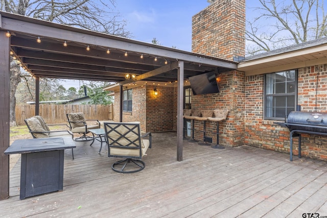 wooden terrace featuring area for grilling