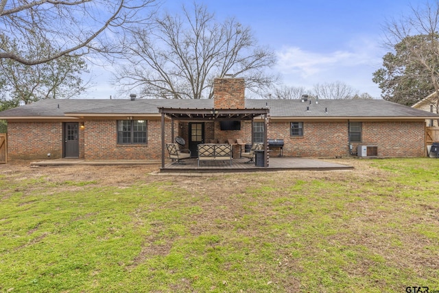 rear view of property with an outdoor living space, central air condition unit, a yard, and a patio