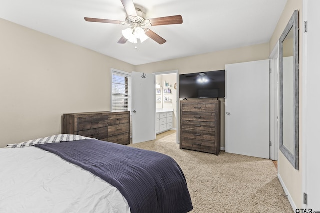 carpeted bedroom featuring ceiling fan and connected bathroom