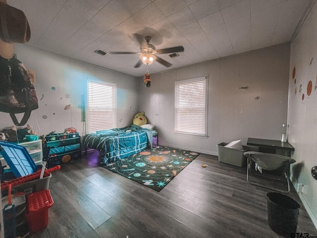 bedroom with dark wood-type flooring and ceiling fan