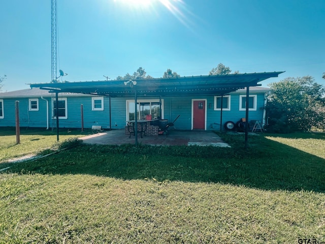 view of front of house featuring a front yard and a patio