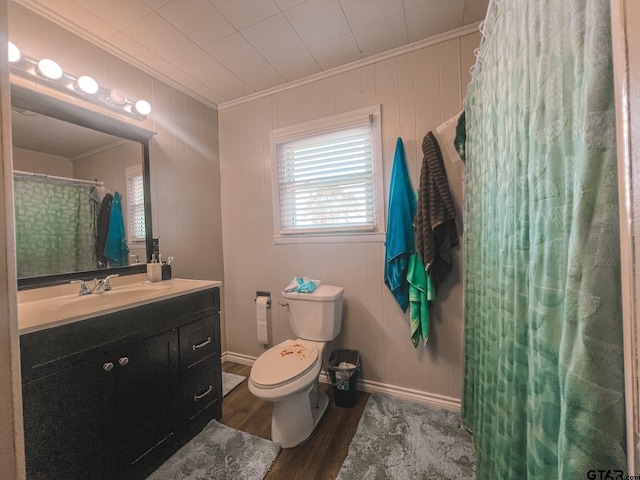 bathroom featuring wood-type flooring, toilet, wood walls, vanity, and crown molding