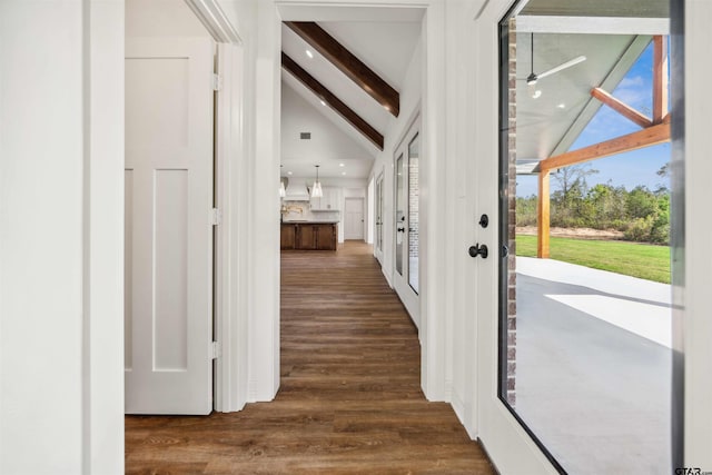 entrance foyer featuring vaulted ceiling with beams and dark hardwood / wood-style flooring