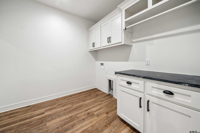 clothes washing area with dark hardwood / wood-style floors, cabinets, and hookup for a washing machine