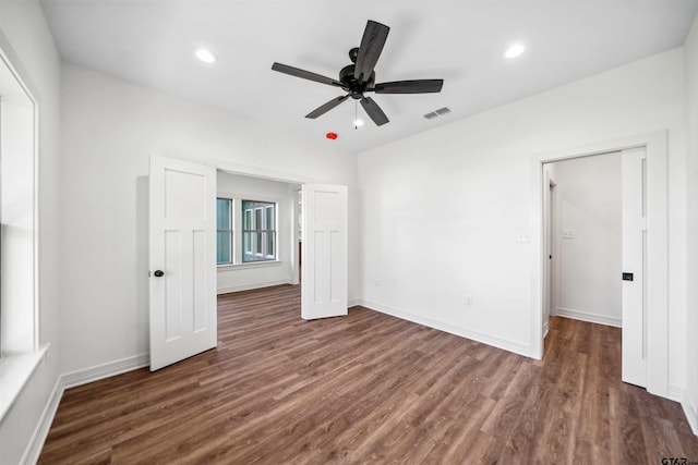 unfurnished bedroom featuring ceiling fan and dark wood-type flooring