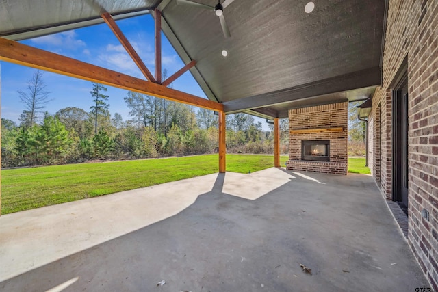 view of patio with an outdoor brick fireplace