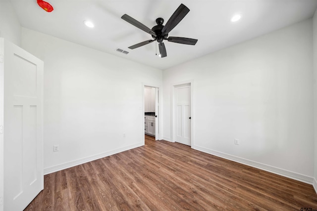 spare room featuring ceiling fan and dark hardwood / wood-style flooring