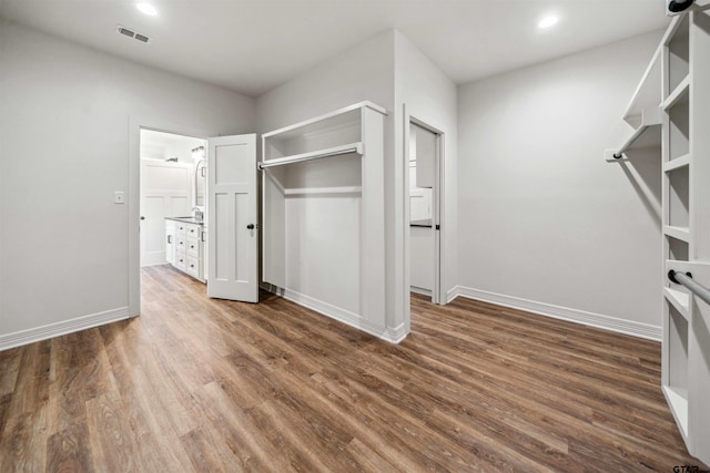 unfurnished bedroom with a closet and dark hardwood / wood-style flooring