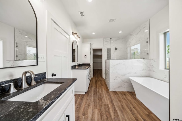 bathroom featuring separate shower and tub, vanity, and hardwood / wood-style flooring