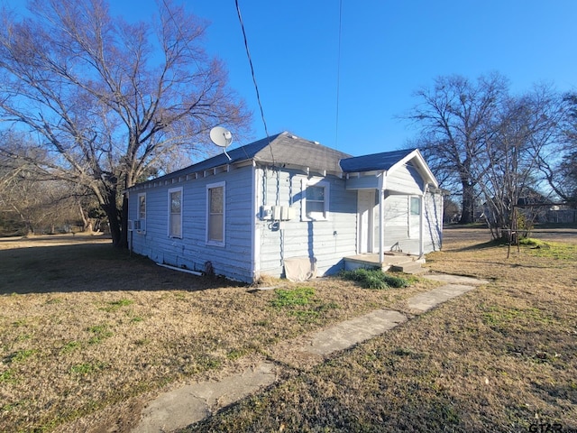 view of property exterior featuring a lawn