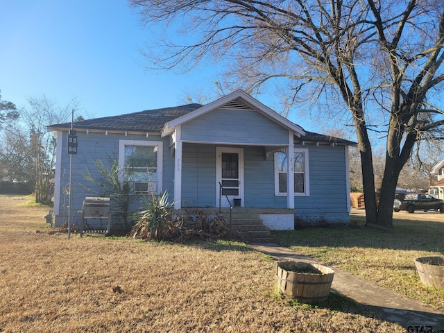 bungalow with a front yard and a porch