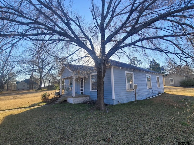 view of property exterior featuring cooling unit and a yard