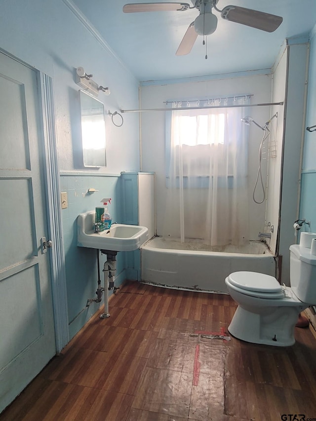 bathroom with crown molding, ceiling fan, shower / washtub combination, hardwood / wood-style floors, and toilet