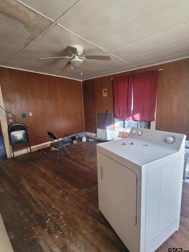 clothes washing area featuring ceiling fan, washer / dryer, wood walls, and dark hardwood / wood-style floors