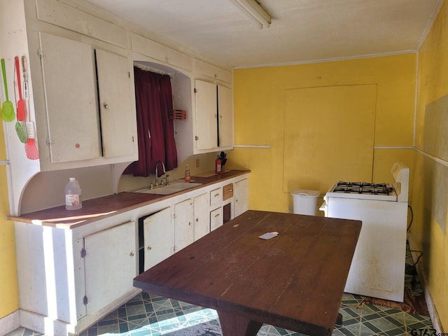 kitchen with sink, white cabinetry, and ornamental molding