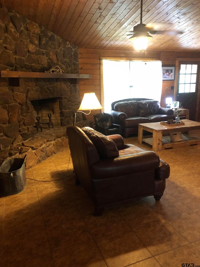 tiled living room featuring a fireplace, wood walls, and wooden ceiling