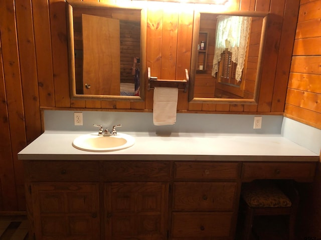 bathroom with wood walls and vanity