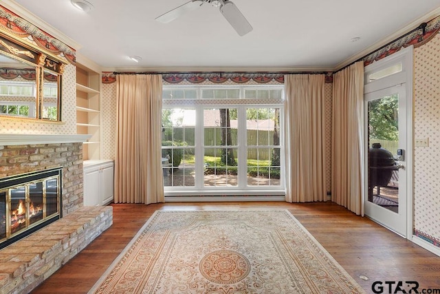 1701 Devonshire Dr, Tyler, TX 75703 - unfurnished living room featuring a ceiling fan, wood finished floors, a fireplace, and ornamental molding
