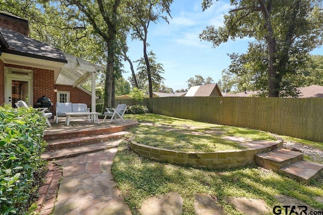 1701 Devonshire Dr, Tyler, TX 75703 - fenced backyard featuring a patio area and outdoor lounge area