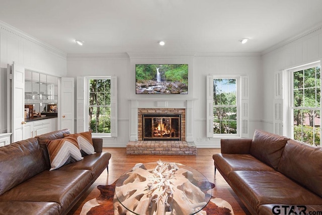 1701 Devonshire Dr, Tyler, TX 75703 - living room with light wood-type flooring, plenty of natural light, a fireplace, ornamental molding, and a decorative wall