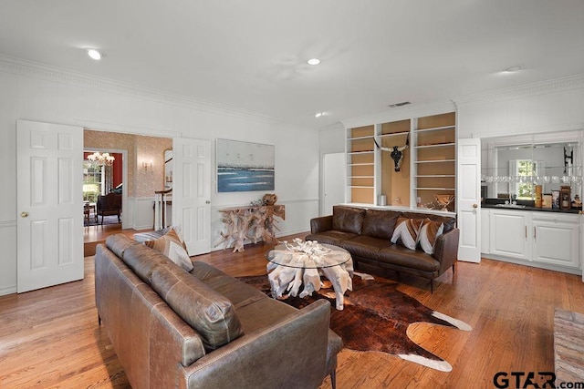 1701 Devonshire Dr, Tyler, TX 75703 - living room featuring ornamental molding, a decorative wall, light wood-style flooring, plenty of natural light, and recessed lighting