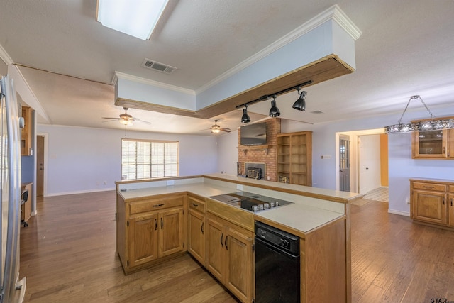 kitchen featuring black electric cooktop, visible vents, a fireplace, ceiling fan, and open floor plan