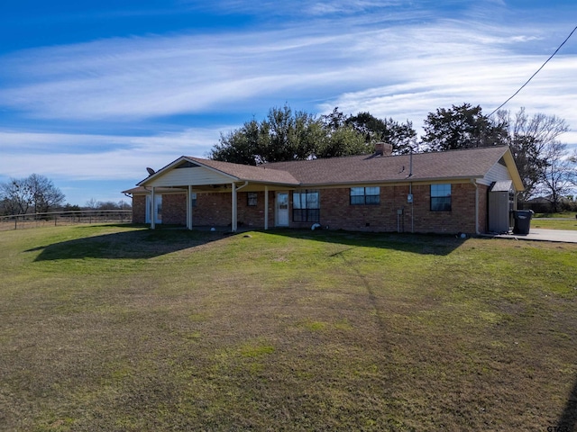 single story home featuring brick siding, a chimney, a front lawn, and fence