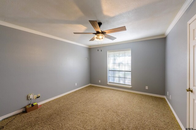 carpeted spare room with baseboards, a textured ceiling, crown molding, and a ceiling fan