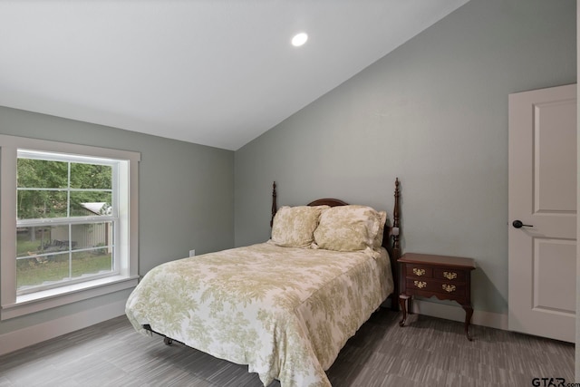 bedroom featuring hardwood / wood-style floors and vaulted ceiling