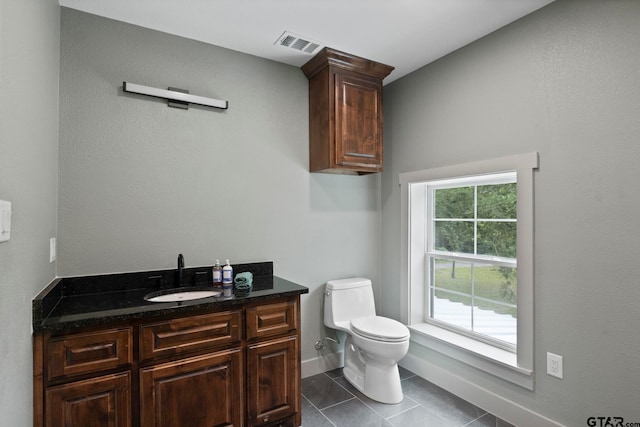 bathroom with vanity, tile patterned floors, and toilet