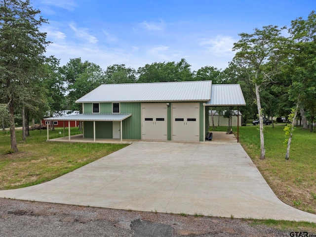 view of front facade with a front lawn and an outbuilding