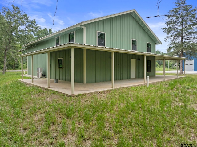 rear view of house with a yard and a patio area