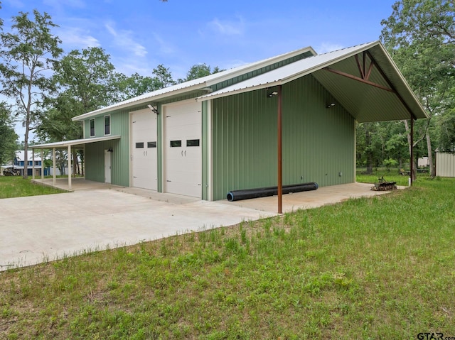 exterior space featuring a lawn, a carport, and a garage