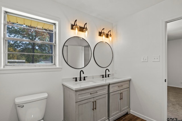 bathroom featuring vanity and toilet