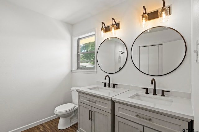 bathroom featuring vanity, wood-type flooring, and toilet