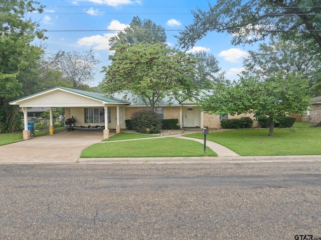 view of front of property featuring a front yard and a carport