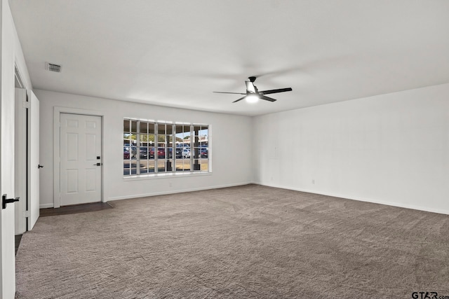 carpeted spare room featuring ceiling fan