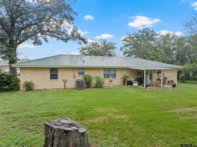 back of property with a yard, a patio, and central AC unit