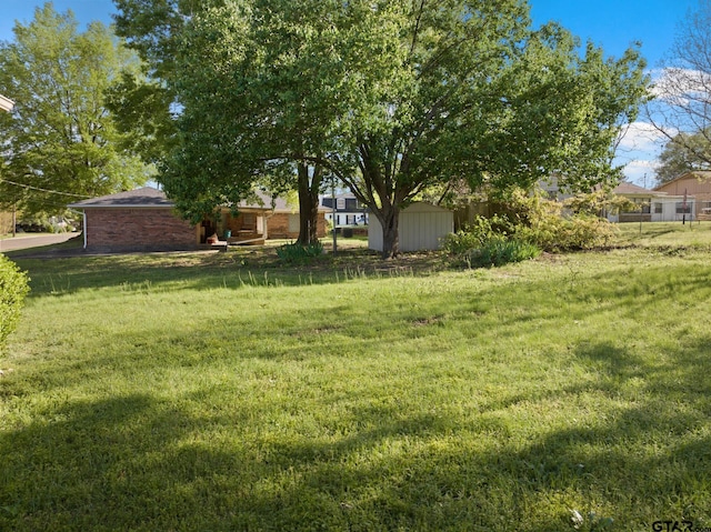 314 Cedar St, Mount Pleasant, TX 75455 - view of yard featuring a storage unit and an outbuilding