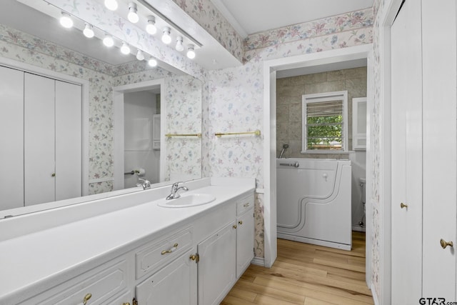 314 Cedar St, Mount Pleasant, TX 75455 - bathroom featuring wallpapered walls and wood finished floors