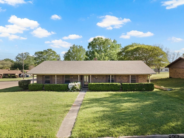 314 Cedar St, Mount Pleasant, TX 75455 - ranch-style home with a shingled roof, a chimney, brick siding, and a front yard