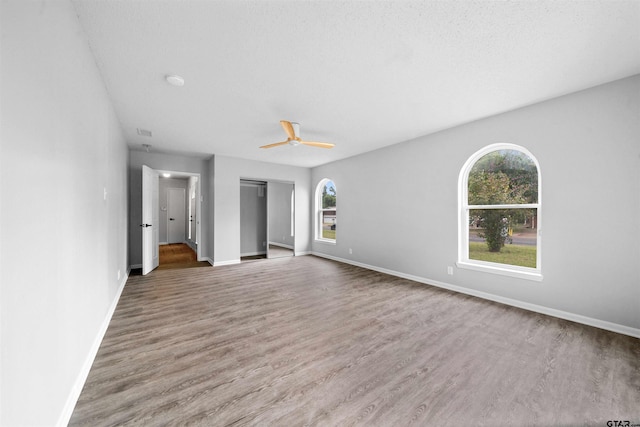 4715 Edinburgh Dr, Tyler, TX 75703 - unfurnished living room with baseboards, wood finished floors, and a ceiling fan