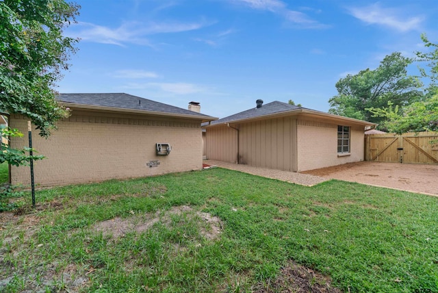 4715 Edinburgh Dr, Tyler, TX 75703 - back of property featuring a gate, brick siding, and a chimney