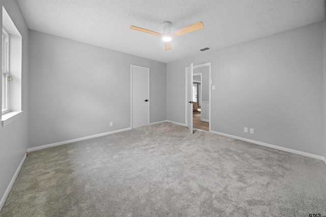 4715 Edinburgh Dr, Tyler, TX 75703 - unfurnished bedroom with carpet floors, a textured ceiling, baseboards, and ceiling fan