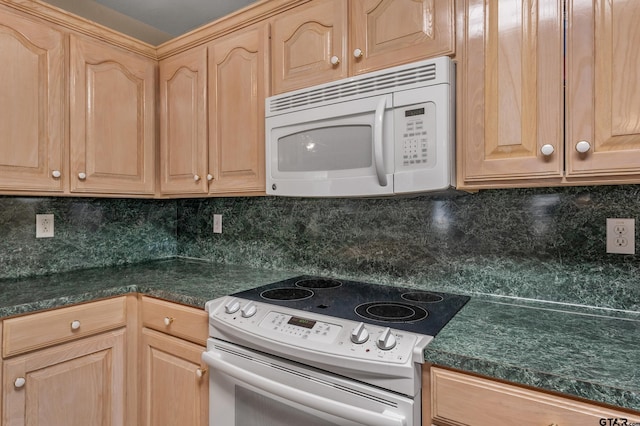 kitchen with white appliances, dark countertops, light brown cabinets, and tasteful backsplash