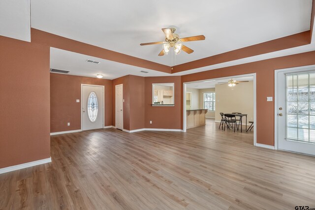foyer featuring light wood-type flooring, visible vents, and a ceiling fan