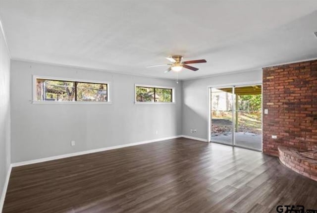 unfurnished room featuring ceiling fan, ornamental molding, dark hardwood / wood-style flooring, and a wealth of natural light