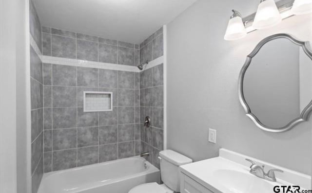 full bathroom with vanity, toilet, and tiled shower / bath combo