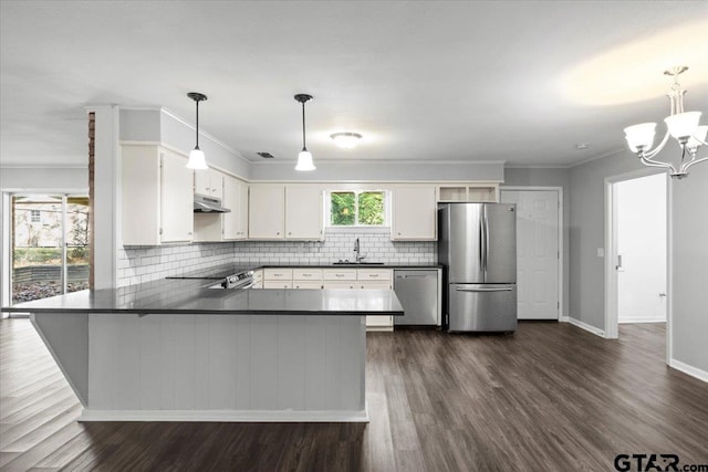 kitchen featuring appliances with stainless steel finishes, pendant lighting, sink, white cabinets, and kitchen peninsula