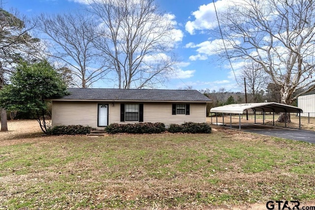 view of front of home featuring aphalt driveway, a front lawn, and a detached carport